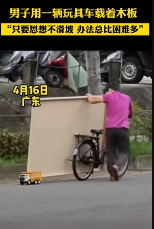 Man using toy truck to carry large wooden frame on road gains plaudits for creativity